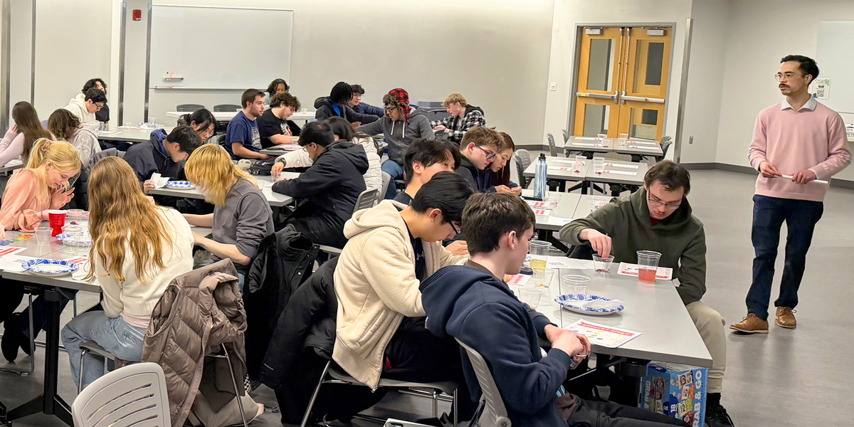 Michael Wan '16 leads students in a round of Grocery Bingo, teaching them about shopping on a budget.