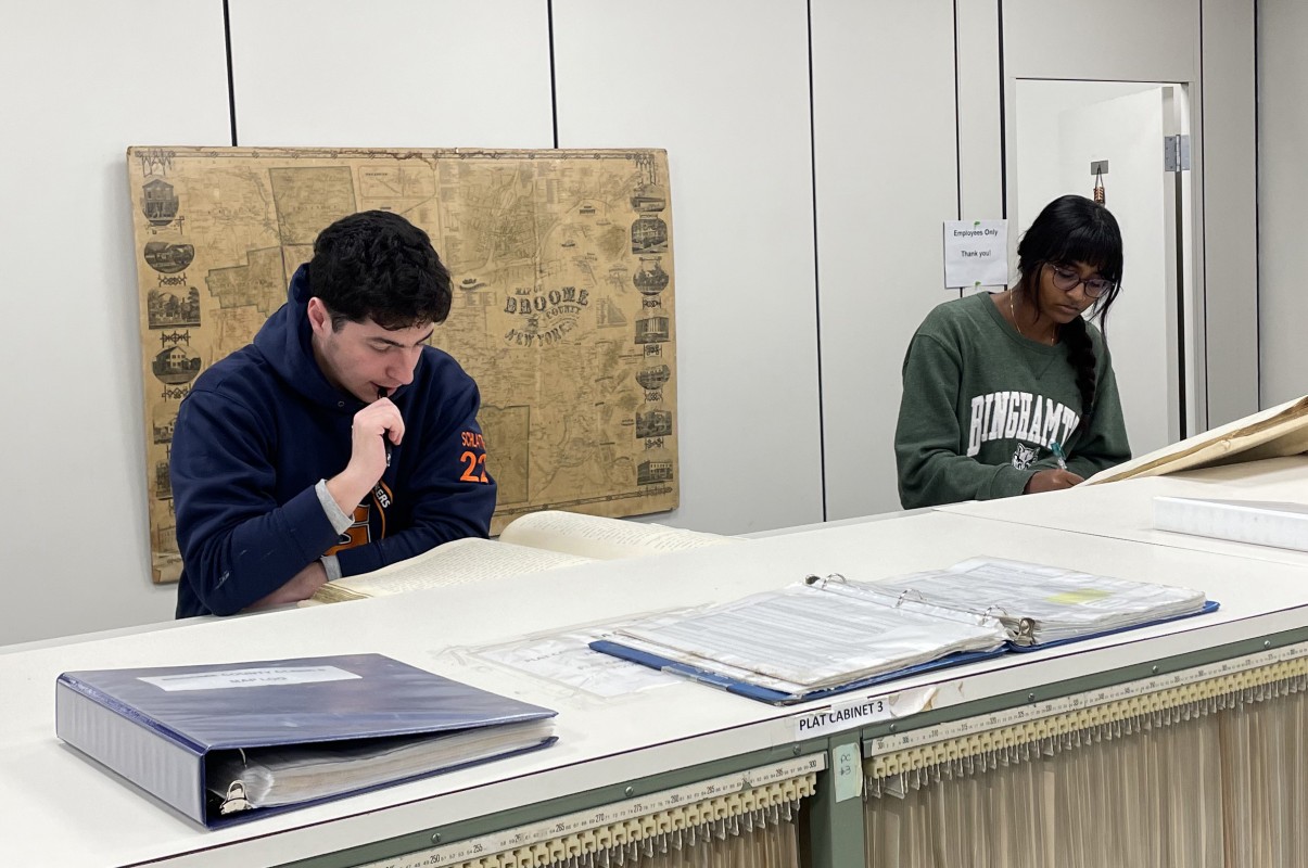Students in Associate Professor of History Wendy Wall’s Source Project stream, Mapping American Prejudice, look through deed books at the Broome County Clerk's Office.
