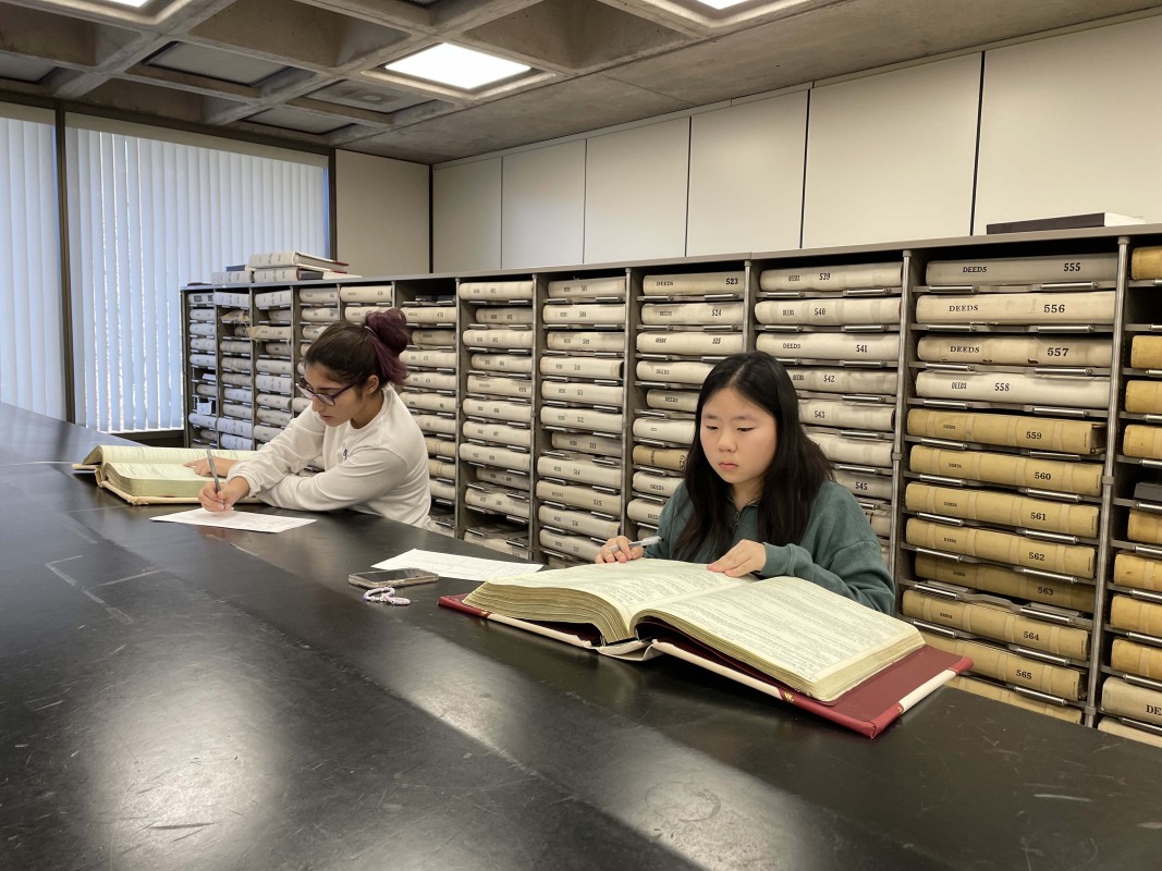 Students in Associate Professor of History Wendy Wall’s Source Project stream, Mapping American Prejudice, look through deed books at the Broome County Clerk's Office.