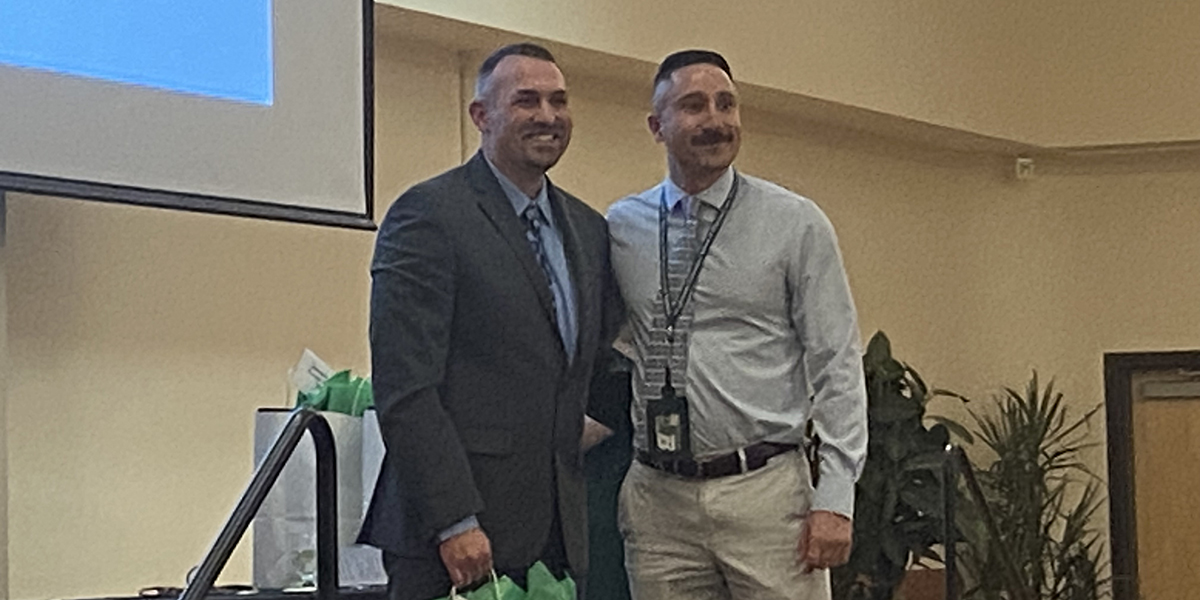 Josh Campbell, left, with Guthrie Robert Packer Hospital in Sayre, Pa., is congratulated by Nicholas Schwier, assistant dean for experiential education and clinical associate professor, for being selected by students as Preceptor of the Year for general medicine.