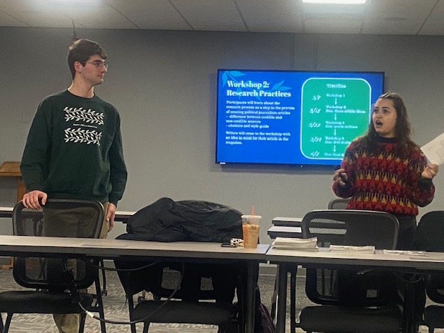Philosophy, politics and law major Trevor Fornara and political science major Amanda Escotto lead a discussion about political science writing at Chenango Valley High School.
