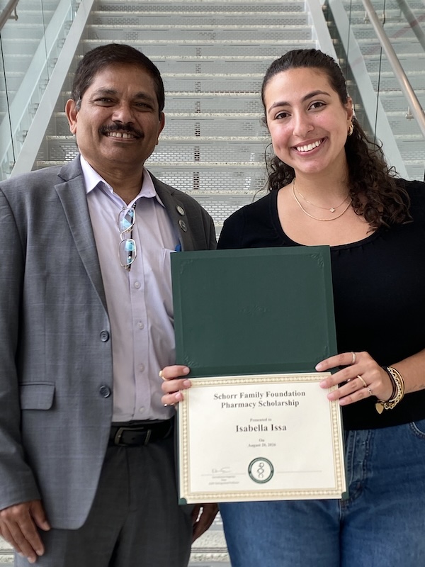 Isabella Issa (right) was presented with the PharmD Scholarship by Dean Kanneboyina Nagaraju (left).