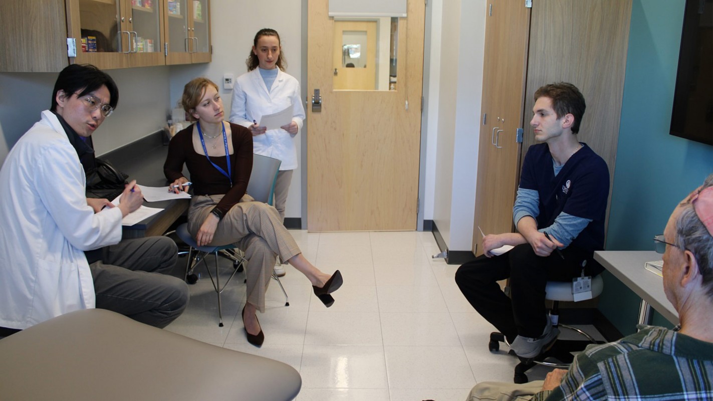 Students from Binghamton University School of Pharmacy and Pharmaceutical Sciences and Upstate Medical interview a patient volunteer.