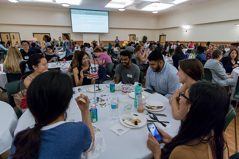 Pharmacy, nursing and social work students collaborate on their first interprofessional activity – selecting their superhero team name – during the Interprofessional Education kick-off dinner Monday, Aug. 21.