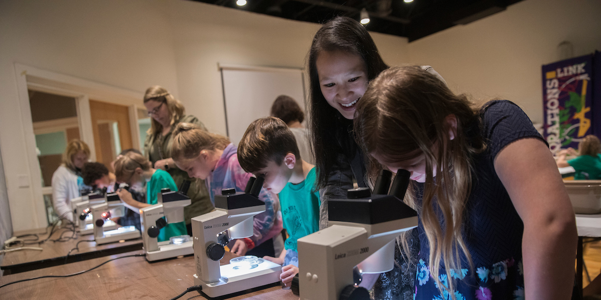 Jessica Hua, associate professor of biological sciences, teaches local children at the Roberson Museum and Science Center in Binghamton.
