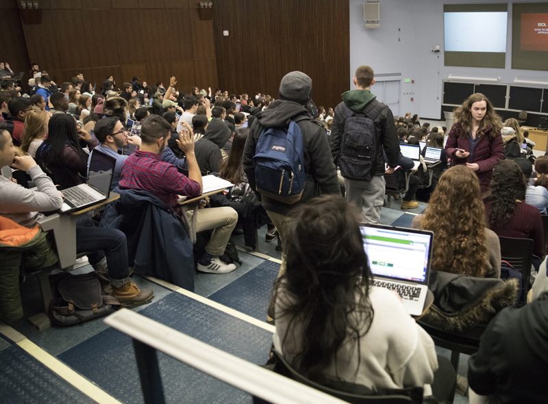 Students pack into a Lecture Hall classroom for a biology course.