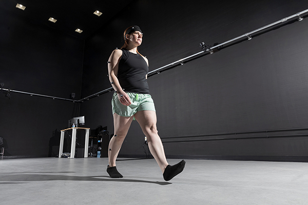 Molly Torbitt, PhD'23, a former graduate assistant at the Motion Analysis Research Lab, demonstrates the 12-camera motion analysis system.