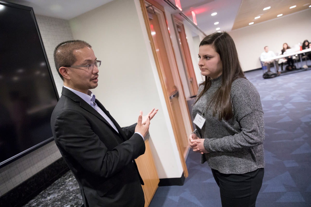 Pictured: Nelson Mar ’94 talks with student during 