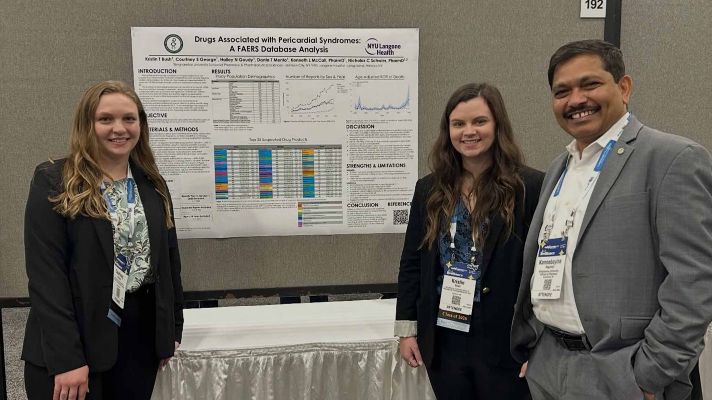 Dean and SUNY Distinguished Professor Kanneboyina Nagaraju (right) poses with P4 students Courtney George (left) and Kristin Bush (Center) at their research poster 