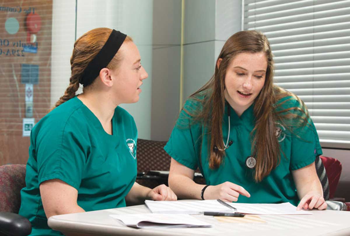 Senior and NSA President MeKenzie VanDermeer (left) and senior Hannah Simmons both participate in the NSA buddy system, providing guidance and support to underclassmen.