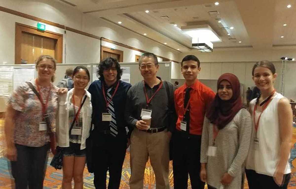 Vestal High School students (from left) Ewa Sulicz, Joyce Zhu, Evan George, Sheng-Liang Slogar, Kashaf Nadeem and Alexis Van Donsel presented a paper at a network science conference in June. They worked with Binghamton University professor Hiroki Sayama, center, throughout the 2016-17 academic year.