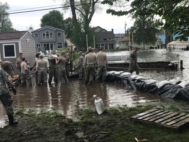 Soldiers of the New York Army National Guard's 105th Military Police Company construct a sandbag barrier to protect property at Sodus Point, N.Y. from flooding due to rising waters on Lake Ontario on May 22, 2017.