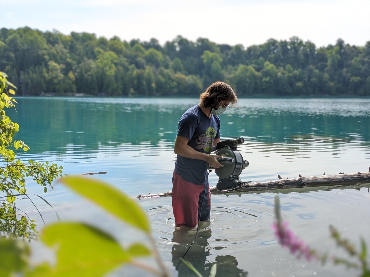 Geological sciences doctoral candidate Kristian Olson in Green Lakes, NY, conducting research with ARCHIE, the department's submersible drone.