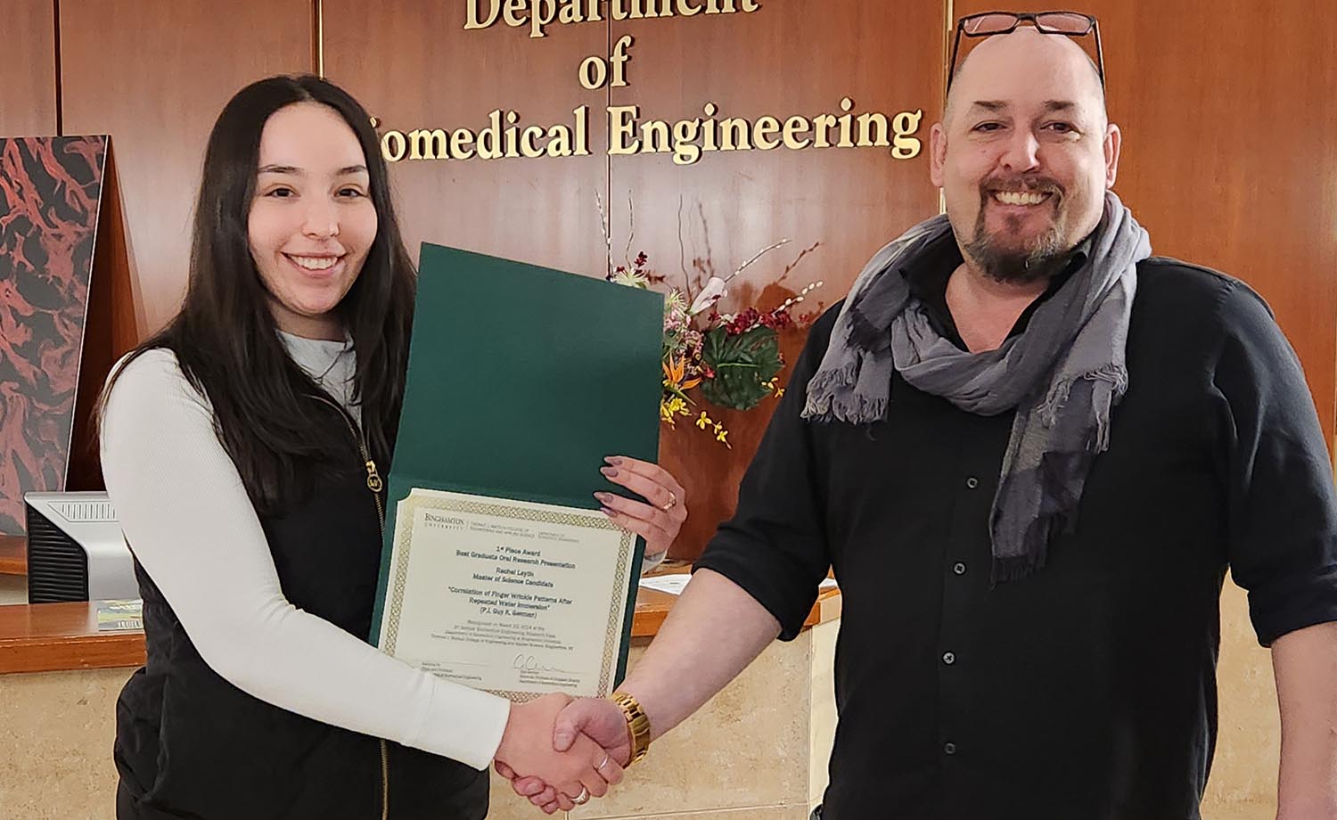Rachel Laytin receives the Biomedical Engineering Research Expo's Best Undergraduate Research Oral Presentation Award from Associate Professor Guy German.
