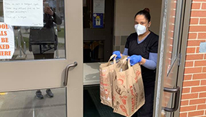 A volunteer with the Rural Health Network prepares to deliver food to those in need.