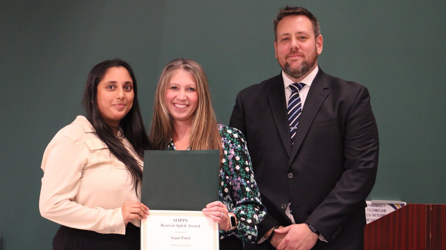 Third-year pharmacy student Sajni Patel accepting her Class of 2027 SOPPS Bearcat Award from Student Success Advisor Erica Folli and Director of Student Affairs James 
