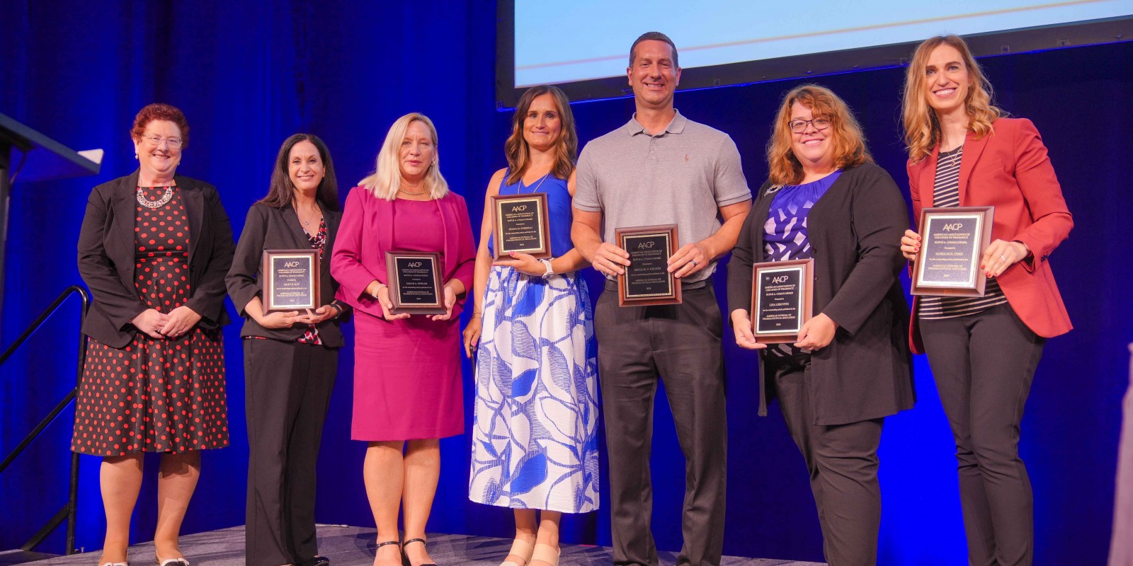 Binghamton Professor and co-chair of pharmacy practice Sarah Spinler (third from left) with her co-authors after receiving the Rufus A. Lyman Award at the 2024 AACP conference in Boston, MA.