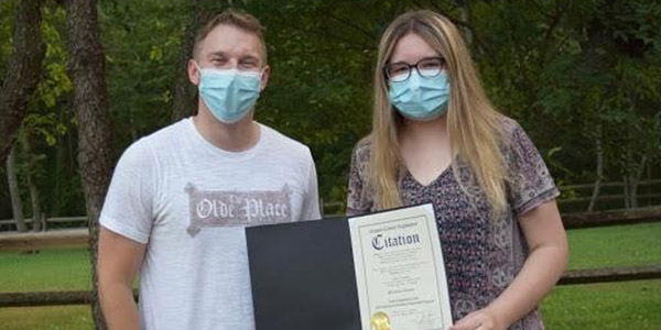Nassau County Legislator Joshua Lafazan and Kiersten Seltzer. Seltzer is holding a certificate of recognition for completing her internship with Lafazan’s office and making strides toward passing the bill.
