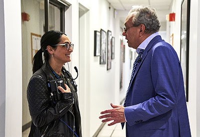 Jen Flanz confers backstage with comedian Lewis Black, a longtime contributor to The Daily Show.