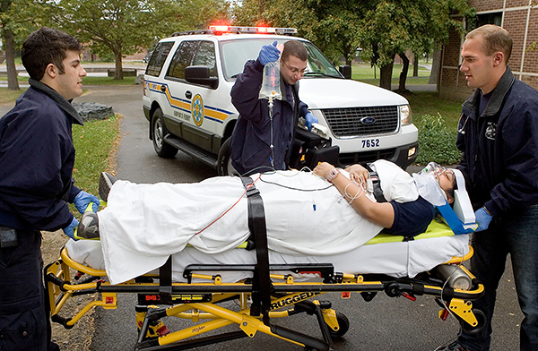 Harpur's Ferry student volunteers practice life-saving exercises near a campus residence hall in 2005.