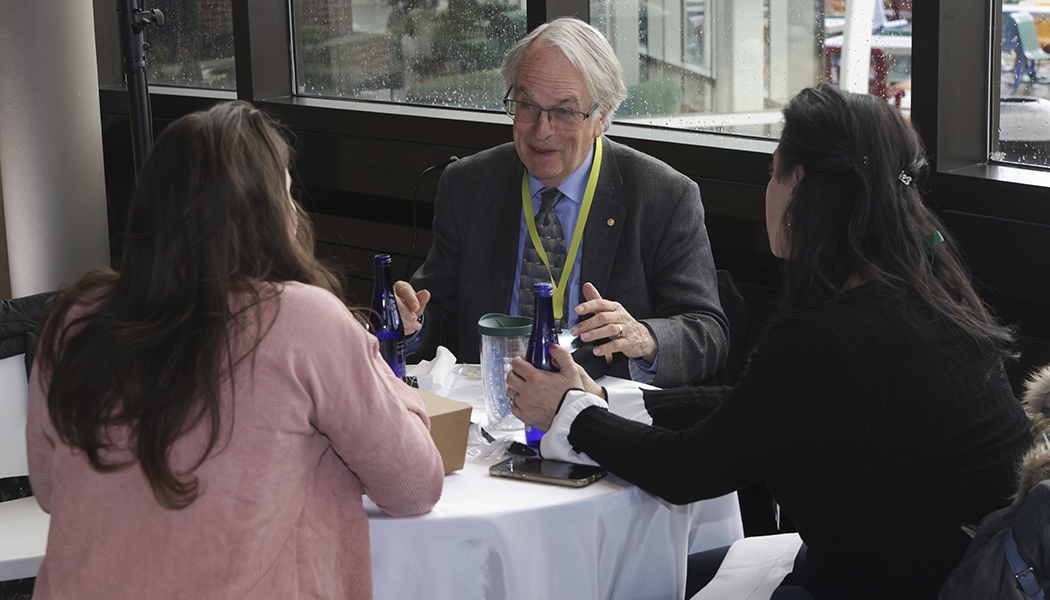 Binghamton's Nobel Prize-winning Distinguished Professor M. Stanley Whittingham speaks with alumni during lunch.