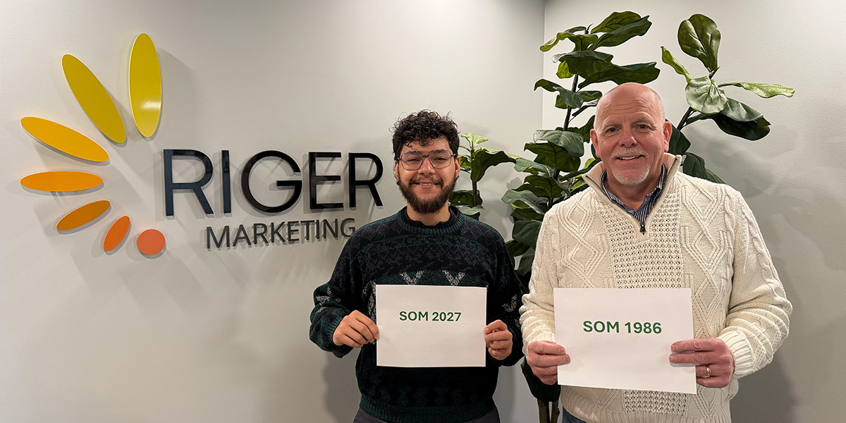 Santiago Perez (left) is a Binghamton University School of Management finance and marketing student interning at Binghamton-based Riger Marketing alongside SOM graduate Steve Johnson '86, who has had a 40-year career in the business.