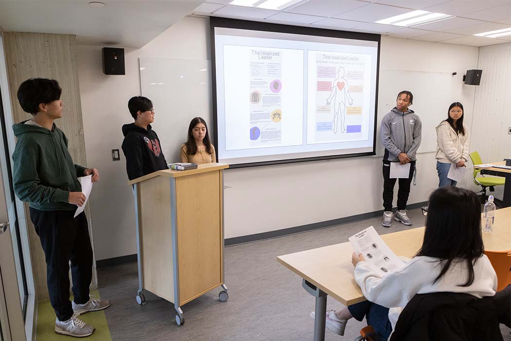 Students in the Transformational Leaders Program at the School of Management deliver a presentation in class April 25, 2023.