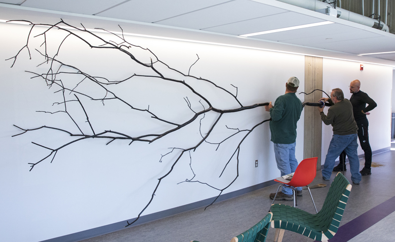 Blazo Kovacevic, right, associate professor of art and design, watches as a dendritic tree is installed on the second floor of Science 4.