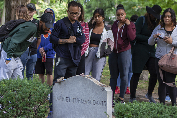 Students in the Black Families course taught by Professor of Human Development Leo Wilton view the grave of Harriet Tubman in Auburn, N.Y., while on a day-trip to learn about her life.