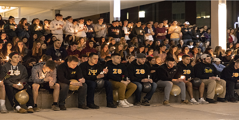 Members of the Zeta Psi fraternity are joined by hundreds of others to celebrate the life of 19-year-old Joao Souza.