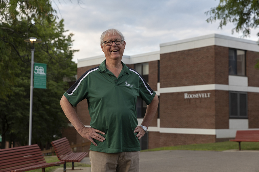 Al Vos stands in front of Hinman College, where he served as collegiate professor.