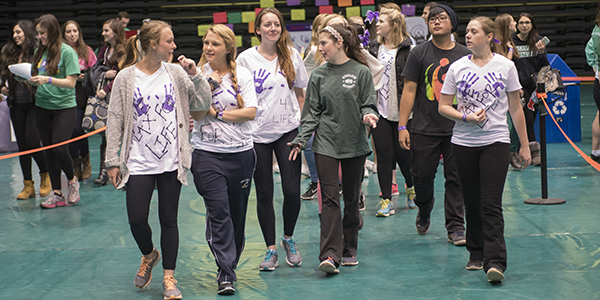 A team from a past Relay for Life in the Binghamton University Events Center walks to raise funds for to support cancer patients.