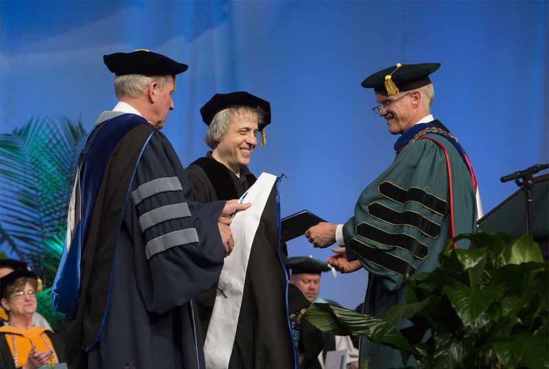 President Harvey Stenger and Provost Donald Nieman prepare to hood Marc Lawrence '81 at the 2016 Graduate School Commencement. Four will be so honored at this year's Graduate School ceremony, Friday, May 19.