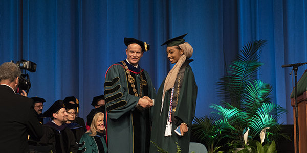 President Harvey Stenger congratulates a graduate during a 2018 Harpur College of Arts and Sciences Commencement ceremony.