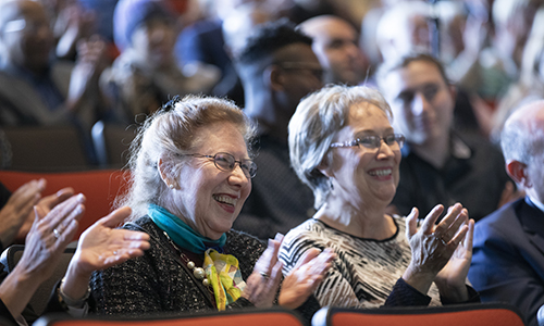 Whittingham's wife, Georgina Whittingham, left, a professor of Spanish and Latin American literature at the State University of New York at Oswego, and Elaine Schmitz, Whittingham's longtime administrative assistant, applaud as he walks onto stage.