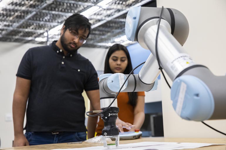 Working in the Autonomous Intelligent Robotics Lab are PhD students Kishan Chandan, left, and Vidisha Kudalkar.
