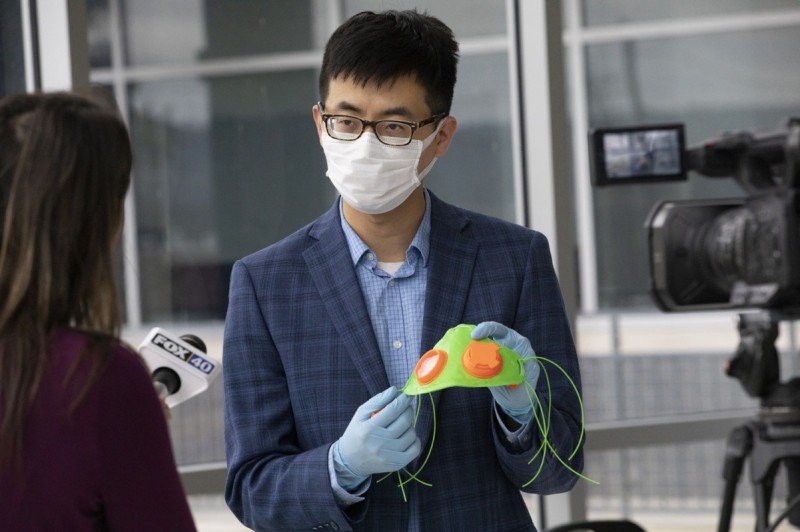 Fuda Ning, an assistant professor in Department of Systems Science and Industrial Engineering, shows a 3D-printed facemask during a media event at the Innovative Technologies Complex. The equipment will be donated to local hospitals to aid the fight against the COVID-19 pandemic.