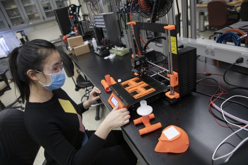 Huimin Zhou, a PhD student in Department of Systems Science and Industrial Engineering, oversees the 3D-printing of ventilator adapters and facemasks at a lab in the Innovative Technologies Complex. The equipment will be donated to local hospitals to aid the fight against the COVID-19 pandemic.