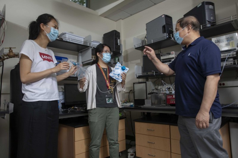 Graduate students Stacey Shan Wang and Sally Guojun Shang with Chuan-Jian Zhong, professor of chemistry, photographed at Zhong’s laboratory in the Smart Energy Building at the Innovative Technologies Complex.