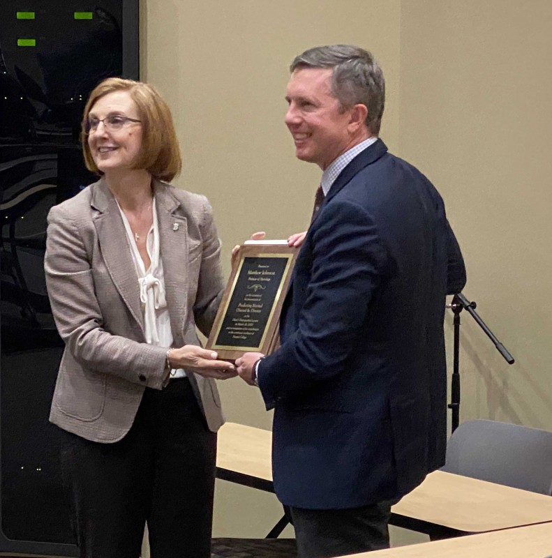 Harpur College Dean Elizabeth Chilton presents Psychology Professor Matt Johnson with a plaque for delivering the 2020 Harpur Dean's Distinguished Lecture on March 10, 2020, at the Innovative Technologies Complex.