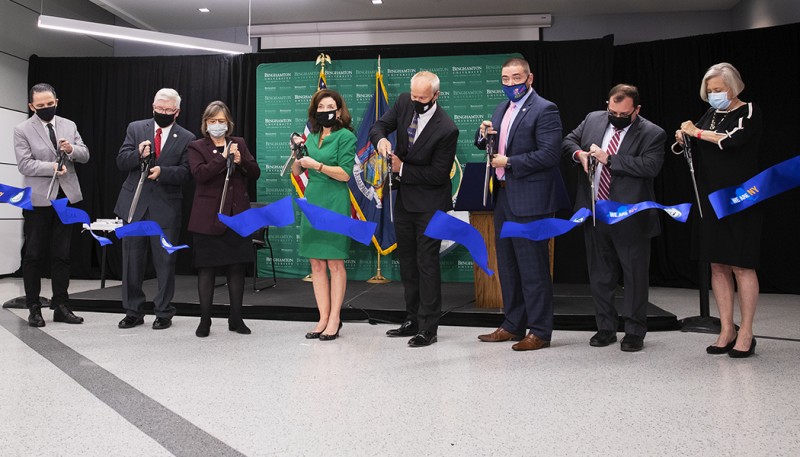 President Harvey Stenger is joined by Gov. Kathy Hochul, local and state legislators, Decker College of Nursing and Health Sciences Dean Mario Ortiz (far left) and School of Pharmacy and Pharmaceutical Sciences Founding Dean Gloria Meredith (far right) at a ribbon cutting ceremony for the Health Sciences Building.