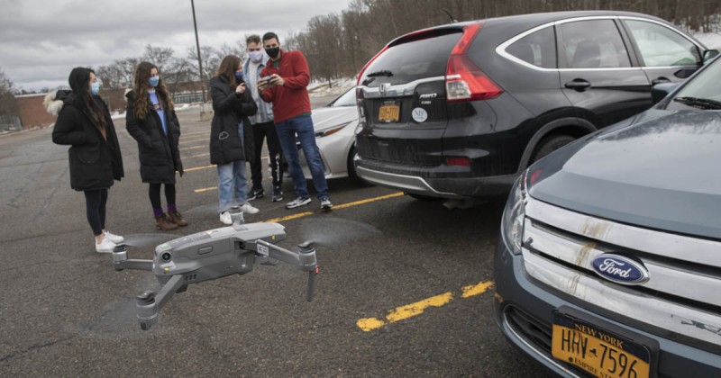 Systems science and industrial engineering students, from left, Irene Yuan, Alexandra Rizopoulos, Lucy Benack, Jordan Congdon and Solomon Barer test their drone for their senior capstone project to find ways to enforce parking rules on campus.