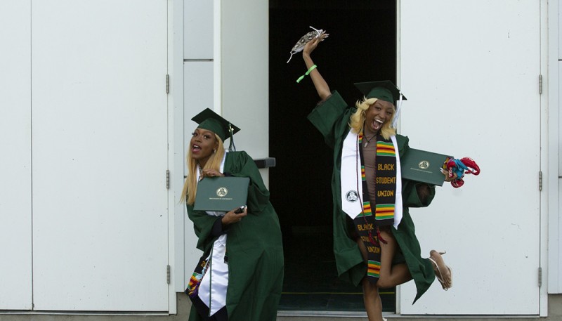Two very happy graduates leave the Events Center after crossing the stage during one of two Grad Walks for the College of Community and Public Affairs.