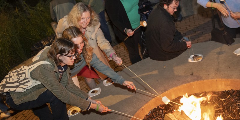 Families enjoy making s'mores at the Friday night bonfire during Family Weekend.