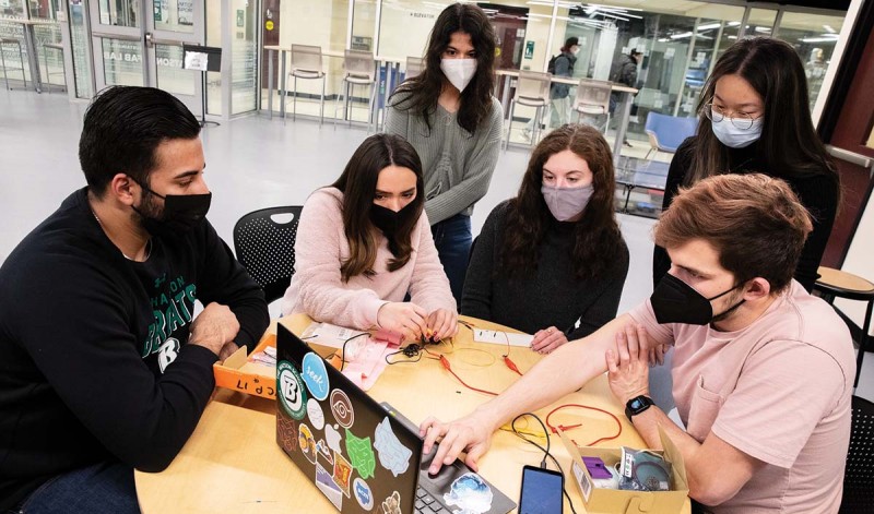 Above: Seniors Ali Cheema, Vanessa Serna Villa, Geena Boasi, Danielle Carucci, Amy Tang and Dylan Macejko
work at the Engineering Building’s Fabrication Lab on their capstone project to build a better bladder sensor.