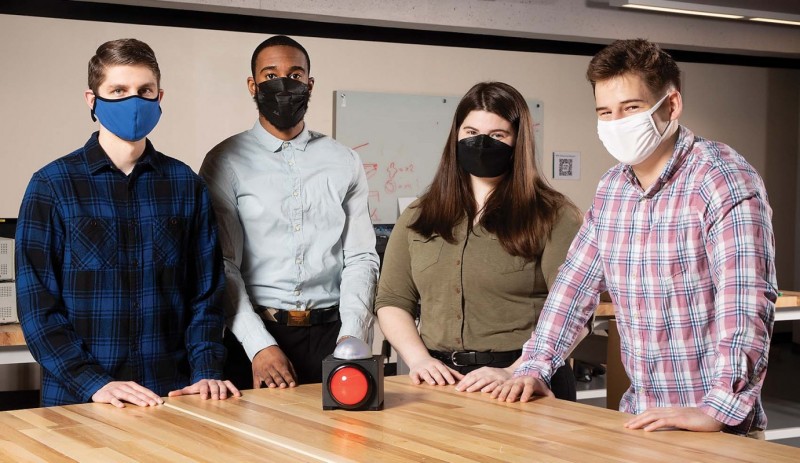 Right: At the Fabrication Lab, from left, Dillon Kane, Brion Byfield, Faith Curtis and Eric Fillingham show
their senior project that will allow a dog to turn on a light for a veteran who has PTSD issues at night.