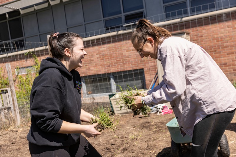 Student volunteers Lizzi Conley and Erin Winn help BrieAnna S. Langlie, assistant professor of anthropology, and Barrett Brenton, faculty engagement associate at the Center for Civic Engagement, set the stage at Science 1 for an Indigenous Garden of the three sisters, Friday, April 29, 2022.