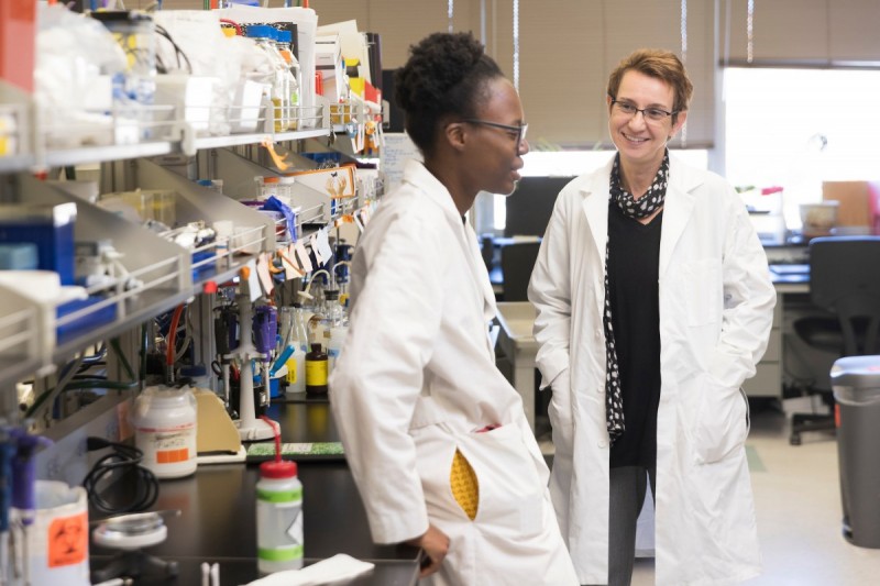 Professor and Chair of Biological Sciences Karin Sauer (right) talks in her laboratory with fifth-year PhD student Victoria Oladosu.