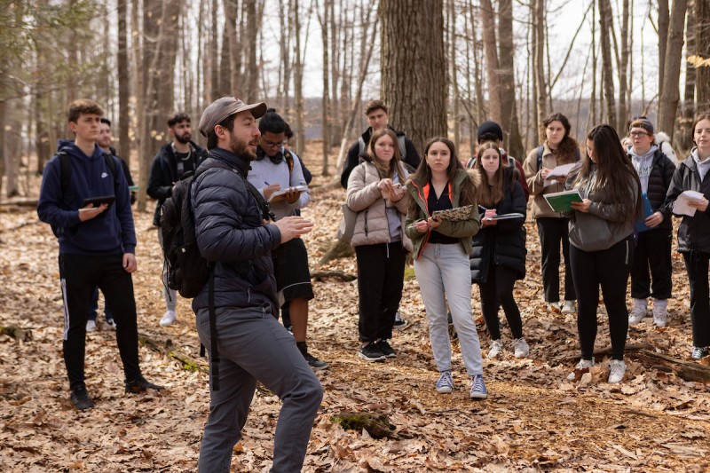 Elias Miller, a PhD candidate in biological sciences, leads his hiking class at the Nature Preserve, March 24, 2023.