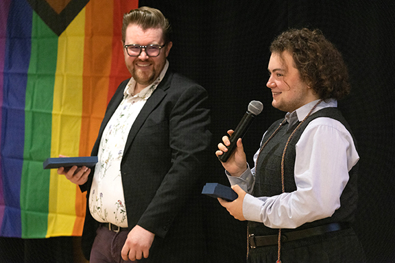 Noah Zimmer (right) receives the Q Center's Activism Award from assistant director Nick Martin.